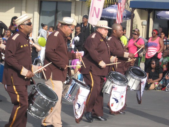 Drummers perform with pride on parade route.