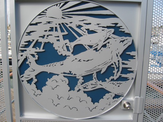 Whales depicted on a Harbor Island marina gate.