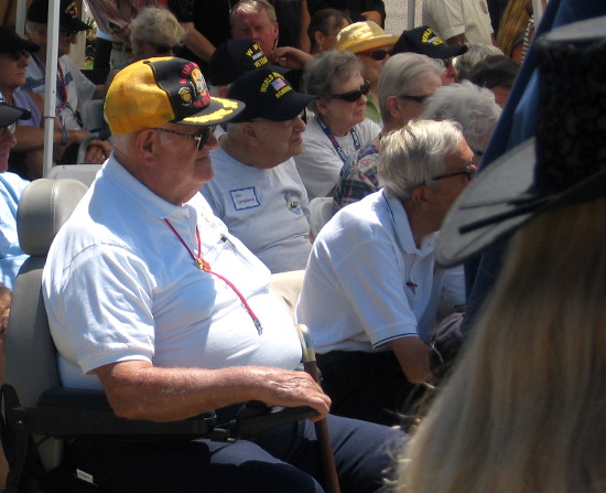 A generation of veterans listens as speakers honor their sacrifices for freedom.