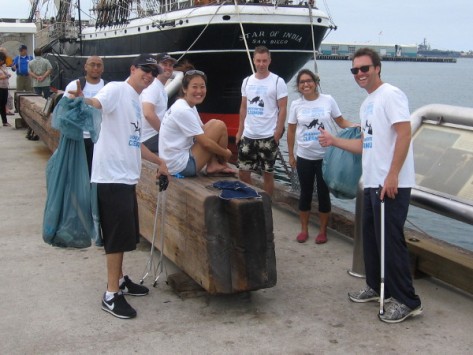 Volunteers help clean up San Diego Bay near the Star of India.