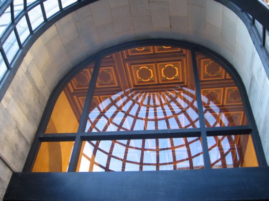 Looking up through the elegant building entrance at the lobby's ceiling.