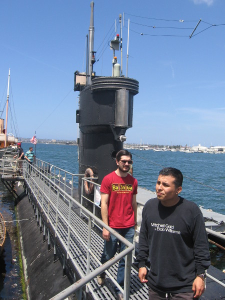 Walking along the deck to forward end of the submarine. The tower-like sail contains the bridge, periscope and communications masts.