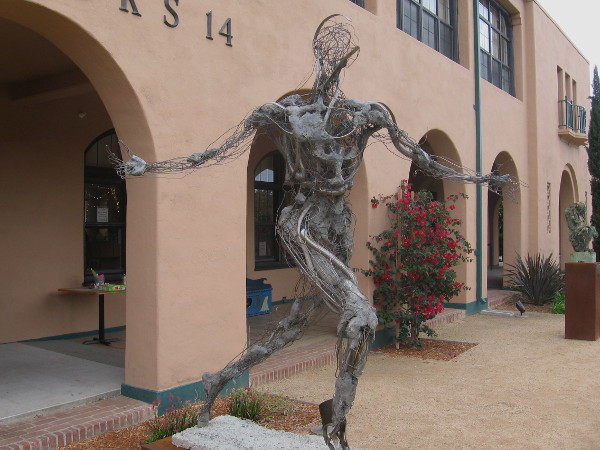 Runner by Robert Michael Jones with strange muscle, bone and energy. Three pieces by this artist stand in front of NTC Liberty Station's Barracks 14.