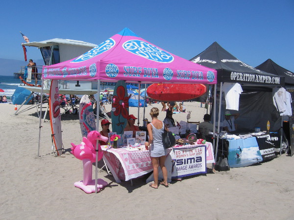 The Surf Diva has a big pink canopy on the sand!