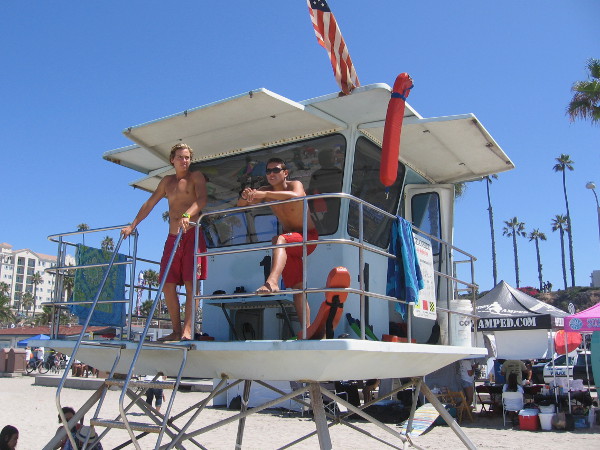 A couple of lifeguards watch the huge crowd from their tower on Oceanside's always popular beach.