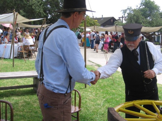 A ship's purser greets the friendly wheelwright in Old Town San Diego State Historic Park during Stagecoach Days: Trades That Shaped the West.