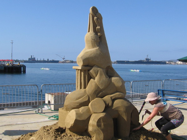 Morgan Rudluff's sand sculpture is Perseverance. It appears to be a tower of Greek columns and abstract human forms.