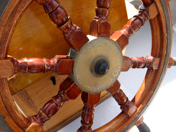 Close look at wooden steering wheel of the beautiful tall ship American Pride.