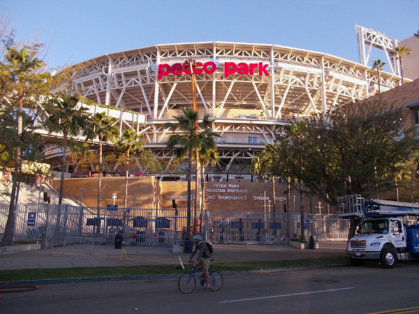 Bicyclist heads down Park Boulevard past a new sight in East Village--a redesigned red sign for Petco Park, just in time for Opening Day and the upcoming 2016 MLB All-Star Game.