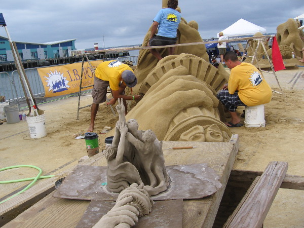 These creative people are the I.B. Posse. Their sand sculpture is titled United We Stand.