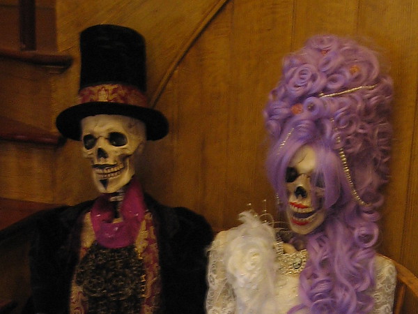 Two elegantly dressed skeletons can be seen seated just inside the front entrance of the Cosmopolitan Hotel in Old Town.