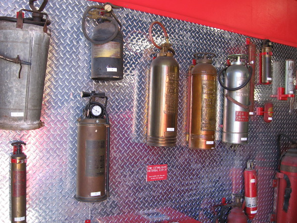 One wall features a collection of old fire extinguishers.
