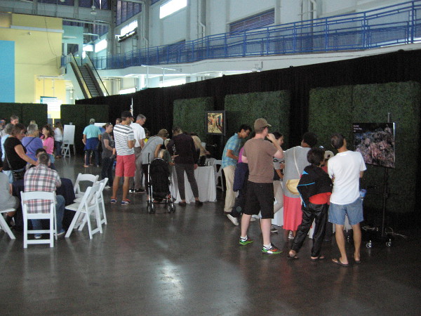 People inside the Port Pavilion learn about science and technology related to the understanding of planet Earth's oceans.