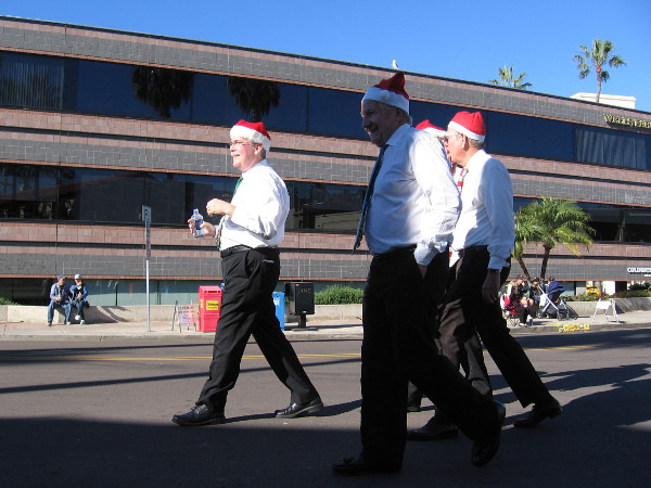While people gathered along the parade route, these four guys in Santa hats came strolling along. They were singers!