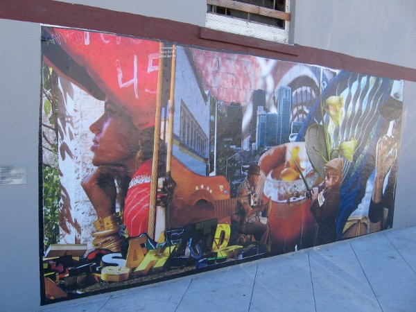 Colorful faces and complex depth are elements of a public mural located in Golden Hill.