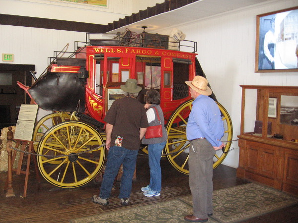 Tourists in Old Town check out a red Wells Fargo stagecoach, which transported mail, gold, goods and passengers in the Old West.