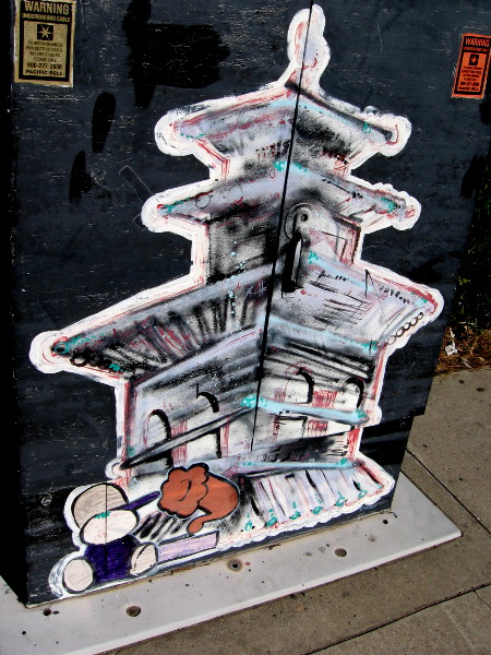 Kid with phonograph sits at base of a pagoda in this unique street art.