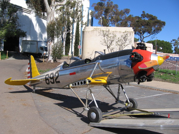 A shiny PT-22 military trainer aircraft from the World War II era is about to be towed from the San Diego Air and Space Museum to their annex at Gillespie Field.