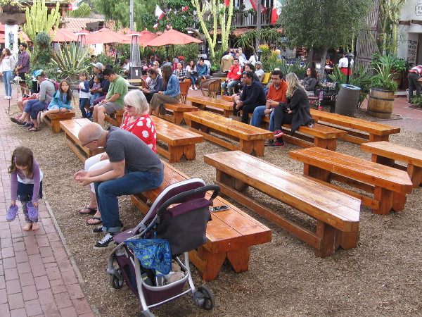 Outdoor benches at Fiesta de Reyes allow visitors to relax and watch the free entertainment.