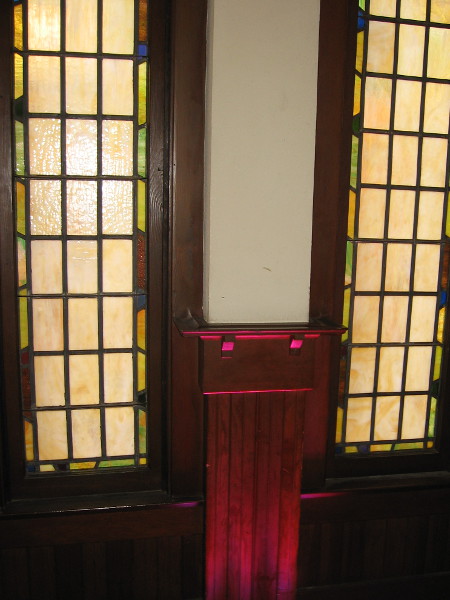 More stained glass behind dining tables on the north side of the second floor.