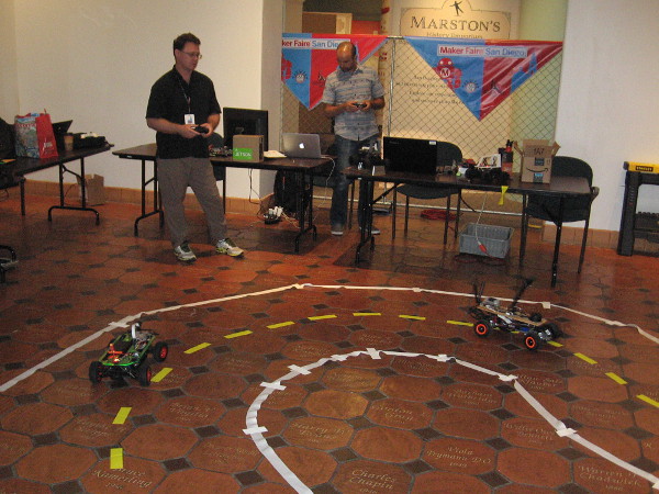Small autonomous cars on a track inside the San Diego History Center. They were being controlled remotely in order to gather navigational data.