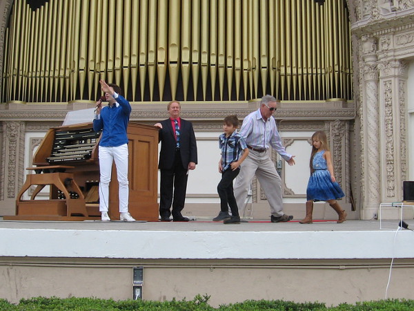 Kids from the audience take the stage right next to the Spreckels Organ console.