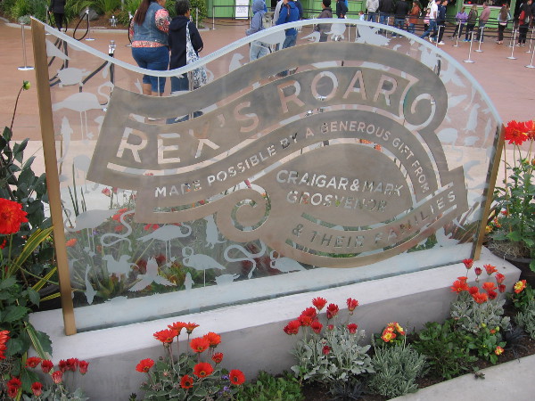 Another nearby sign indicates Rex's Roar was made possible by a generous gift from Craig and Mark Grosvenor and their families.