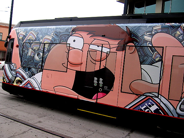 Peter Griffin among lots of beer cans in a Family Guy trolley wrap for SDCC 2018!