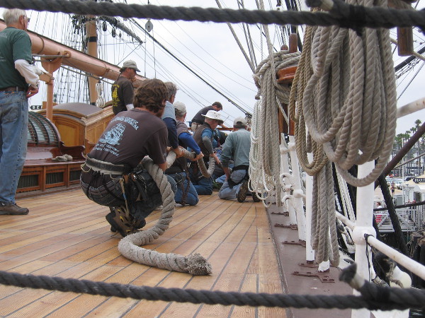Volunteers pull a huge rope together on the deck of Star of India.