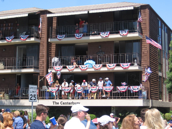 People watch the big parade from a building on Orange Avenue.