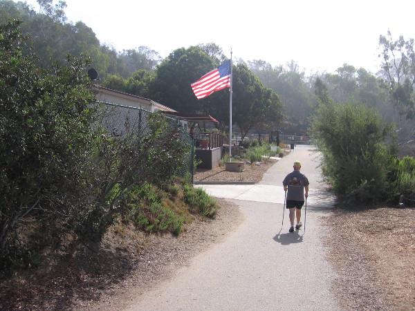 A hiker approaches the Batiquitos Lagoon Nature Center from the Gabbiano Lane trailhead.