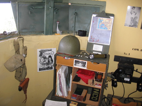 Objects displayed include a map, helmet, canteen and pin-up girl on the wall. A WWII veteran who served at Fort Rosecrans helped to make the bunker's interior appear historically accurate.