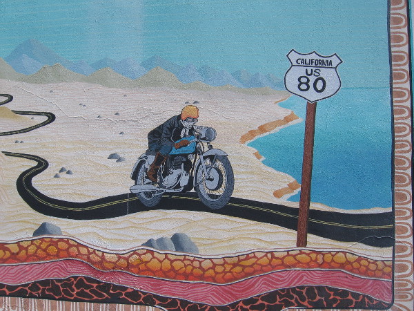 A motorcyclist riding west has reached the Pacific Ocean after crossing desert and mountains.