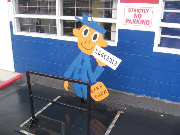 A happy mailman by a bike rack at the Leucadia post office.