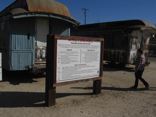 A sign describes two wooden passenger coaches built in the late 19th century. Coach 239 is one of the oldest surviving railroad passenger car artifacts in the West.