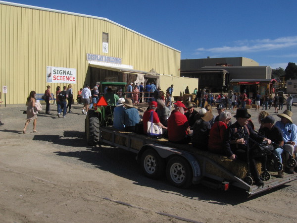 A hay ride pulls up to the Display Building area.
